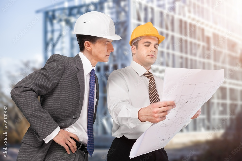 Architect working with colleagues in the construction site. Architecture engineering at workplace. Architect working with colleagues in the construction site. Architecture engineering at workplace.