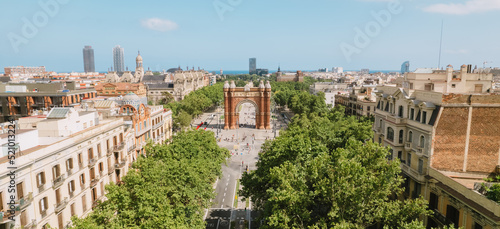 Aerial view of Barcelona Urban Skyline and The Arc de Triomf or Arco de Triunfo in spanish, a triumphal arch in the city of Barcelona. Sunny day.
