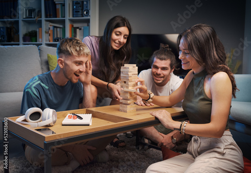 Group of friends playing Jenga together