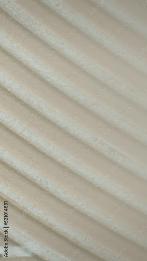 Embossed striped pattern on the wall, close-up. Abstract background Embossed striped pattern on the wall, close-up. Abstract background