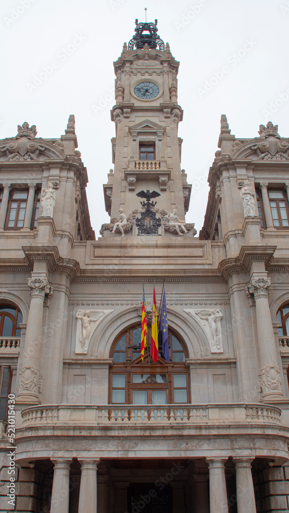 Facade of the city hall of the city of Valencia with flags