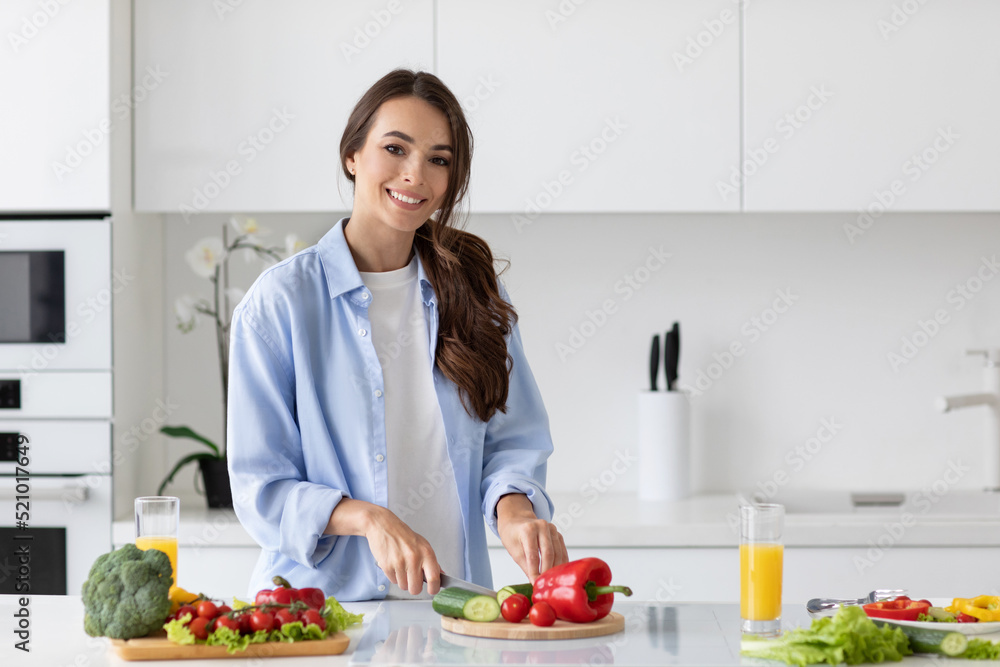 Beautiful smiling healthy woman in the kitchen prepares vegetable healthy breakfast. Beautiful smiling healthy woman in the kitchen prepares vegetable healthy breakfast.
