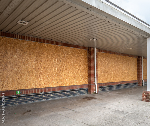 Boarded up windows of a supermarket that has recently  closed down. photo