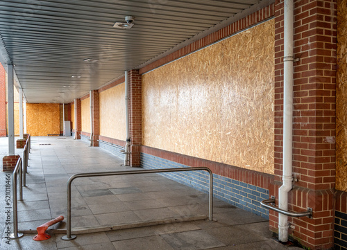 Boarded up windows of a supermarket that has recently  closed down.