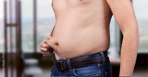 Tableau sur toile Cropped of overweight fat man holding tummy flabs with obesity