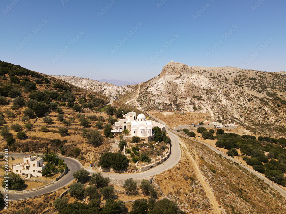panoramic aerial shot drone on white church with background the village of FILOTI, Naxos island, greece. copy space