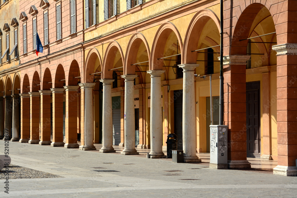 the red arcades of the buildings of Piazza Roma in Modena are a spectacle of color and joy.