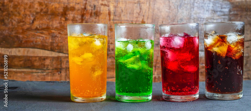 A lot of Soft drinks in colorful and flavorful glasses on the table,Glasses with sweet drinks with ice cubesv
