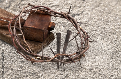 Crucifixion Of Jesus Christ. Cross With Nails And Crown Of Thorns on ground