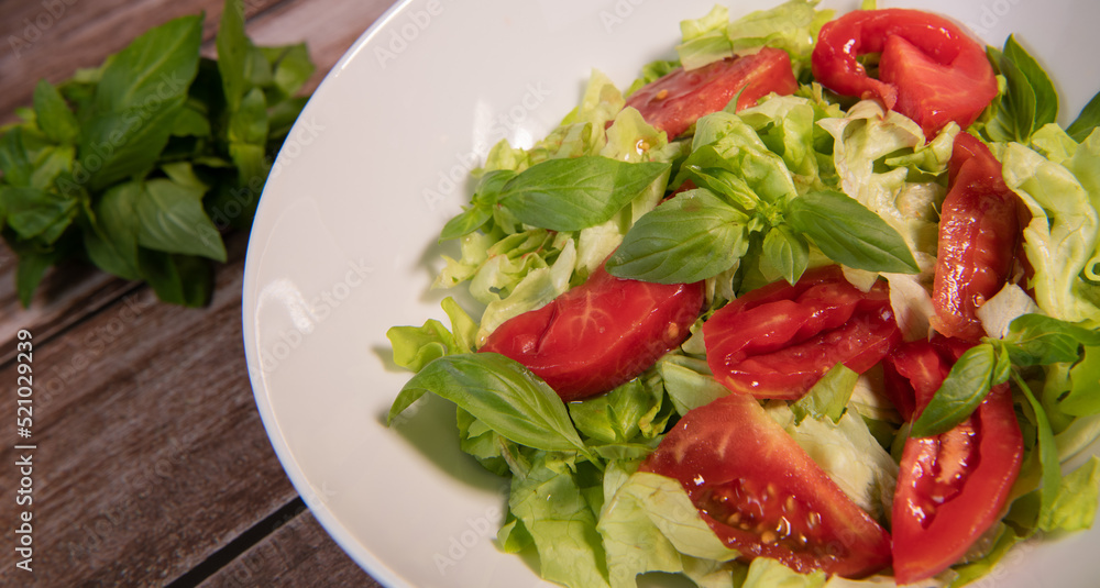 Green vegan salad, tomato and basilic from green leaves mix and vegetables, High quality photo Green vegan salad, tomato and basilic from green leaves mix and vegetables, High quality photo