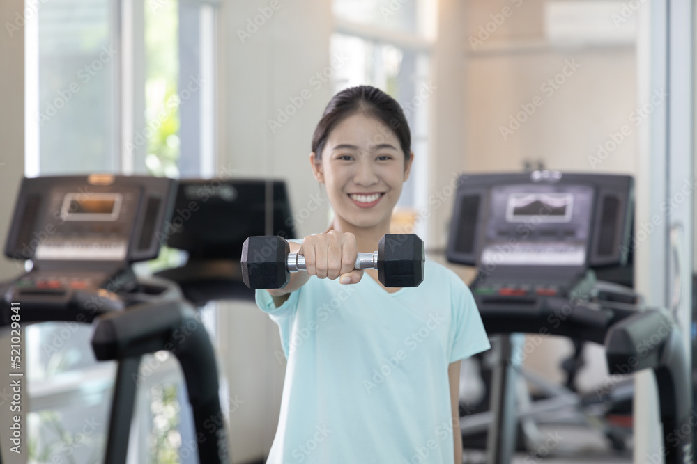 Beautiful and shapely Asian woman working out in the gym, Play exercise machine treadmill, Dumbbell, stretching, Hanging bar, Barbell, Cardio, Stretch, Woman warming up in the gym, Jump rope. Beautiful and shapely Asian woman working out in the gym, Play exercise machine treadmill, Dumbbell, stretching, Hanging bar, Barbell, Cardio, Stretch, Woman warming up in the gym, Jump rope.