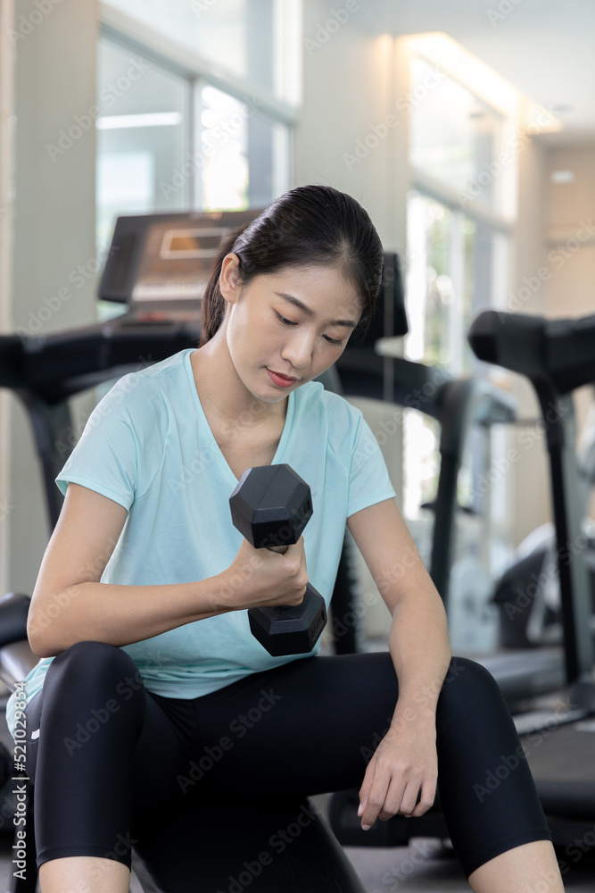 Beautiful and shapely Asian woman working out in the gym, Play exercise machine treadmill, Dumbbell, stretching, Hanging bar, Barbell, Cardio, Stretch, Woman warming up in the gym, Jump rope. Beautiful and shapely Asian woman working out in the gym, Play exercise machine treadmill, Dumbbell, stretching, Hanging bar, Barbell, Cardio, Stretch, Woman warming up in the gym, Jump rope.