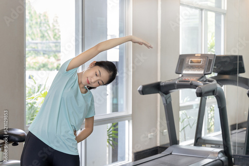 Beautiful and shapely Asian woman working out in the gym, Play exercise machine treadmill, Dumbbell, stretching, Hanging bar, Barbell, Cardio, Stretch, Woman warming up in the gym, Jump rope.