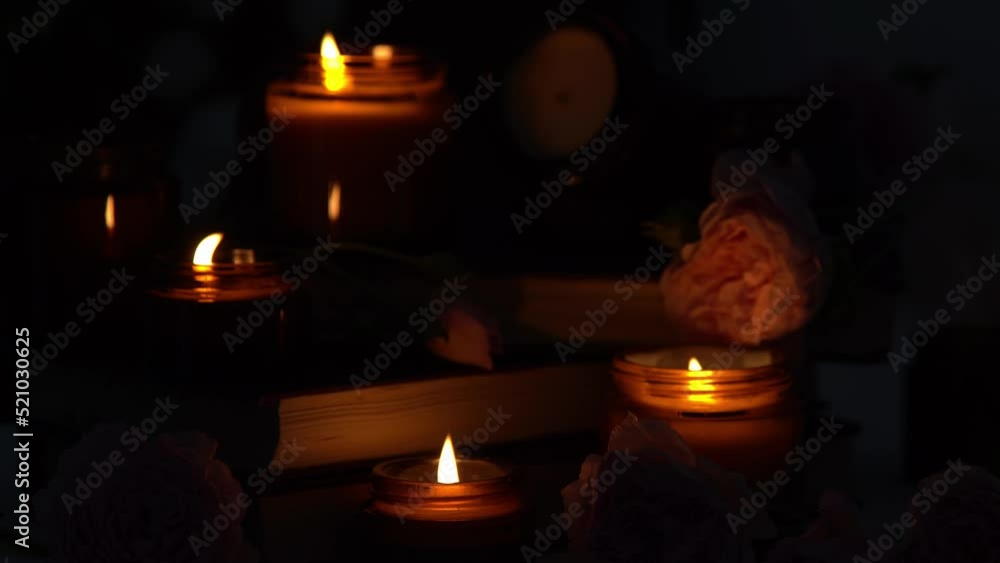 A set of different aroma candles in brown glass jars and flowers. Scented handmade candle. Soy candles are burning in a jar. Aromatherapy and relax in spa and home. Fire in brown jar. Dark evening A set of different aroma candles in brown glass jars and flowers. Scented handmade candle. Soy candles are burning in a jar. Aromatherapy and relax in spa and home. Fire in brown jar. Dark evening
