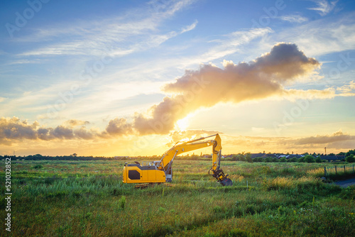 Wheel loader on a green field