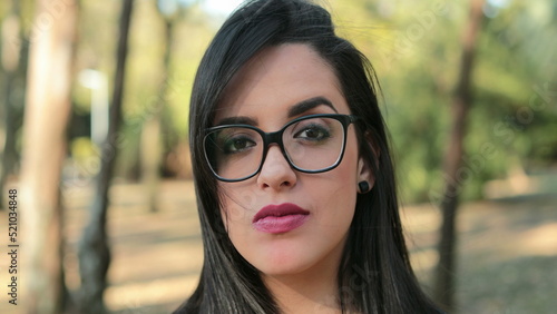 Hispanic woman wearing glasses looking to camera Smart Latina