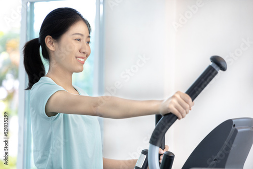 Beautiful and shapely Asian woman working out in the gym, Play exercise machine treadmill, Dumbbell, stretching, Hanging bar, Barbell, Cardio, Stretch, Woman warming up in the gym, Jump rope.