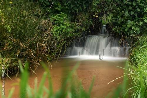 A small waterfall in the woods with water movement