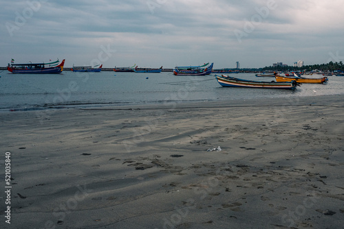 Fishing boats docked in the harbor during the sunset and blue hour
