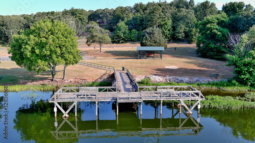 Front aerial view of fishing pier at lake