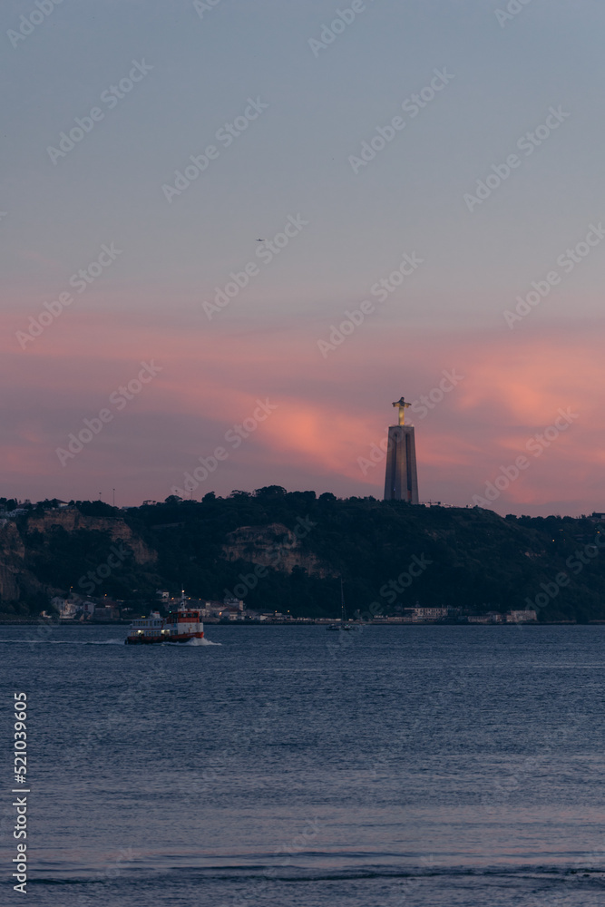 Sunset view of Cristo Rei over the river