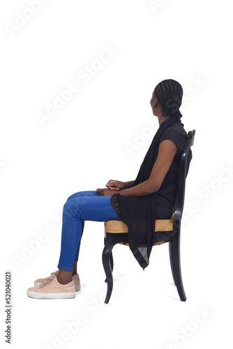 full portrait  of a woman sitting on chair looking background over white background © curto
