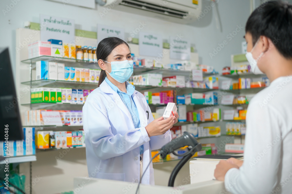 Portrait of female pharmacist wearing face mask in a modern pharmacy drugstore.