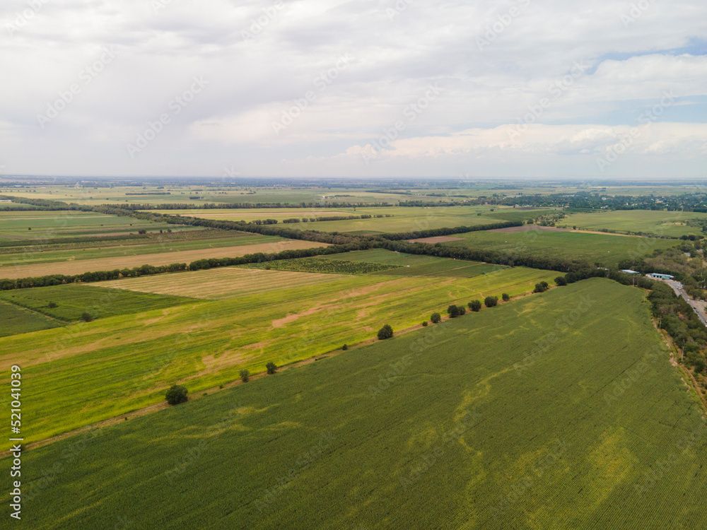 Fantastic landscape, aerial photography from a drone of farmers' fields against the background of mountains. Farm lands and fields are not far from Almaty.