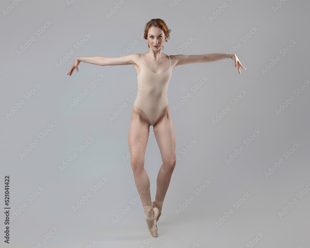 charming ballerina posing in the studio on a white background