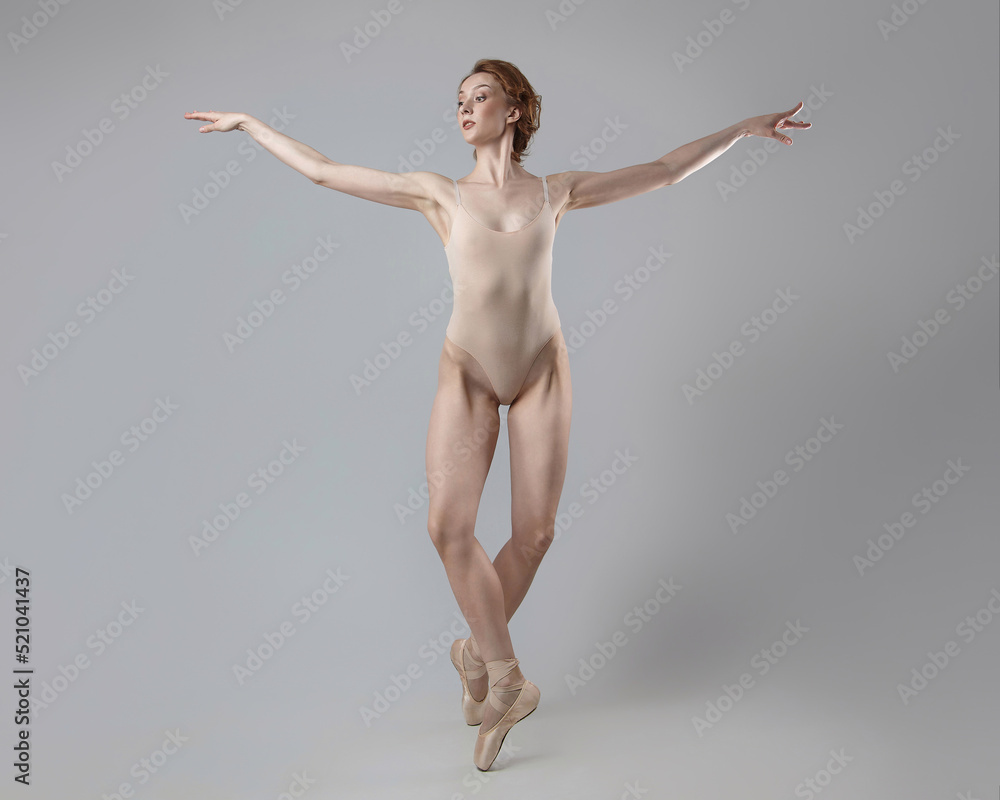 charming ballerina posing in the studio on a white background