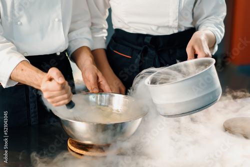 Professional kitchen, chefs use liquid nitrogen to cook molecular food in a restaurant