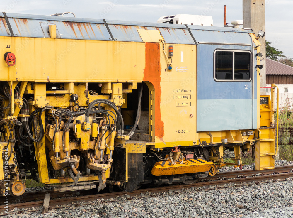 The ballast tamping machine is working to maintain the sleeper and ballast stone. The ballast tamping machine is working to maintain the sleeper and ballast stone.