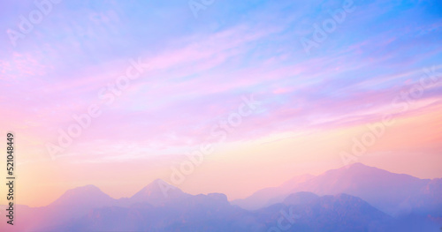 Fotografiet sunrise cloudy sky over mountains; Abstract colorful peaceful sky background