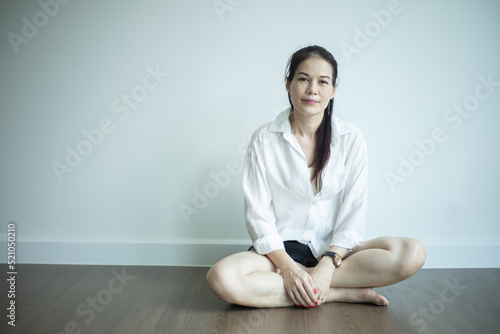 Asian woman sit at her empty new home