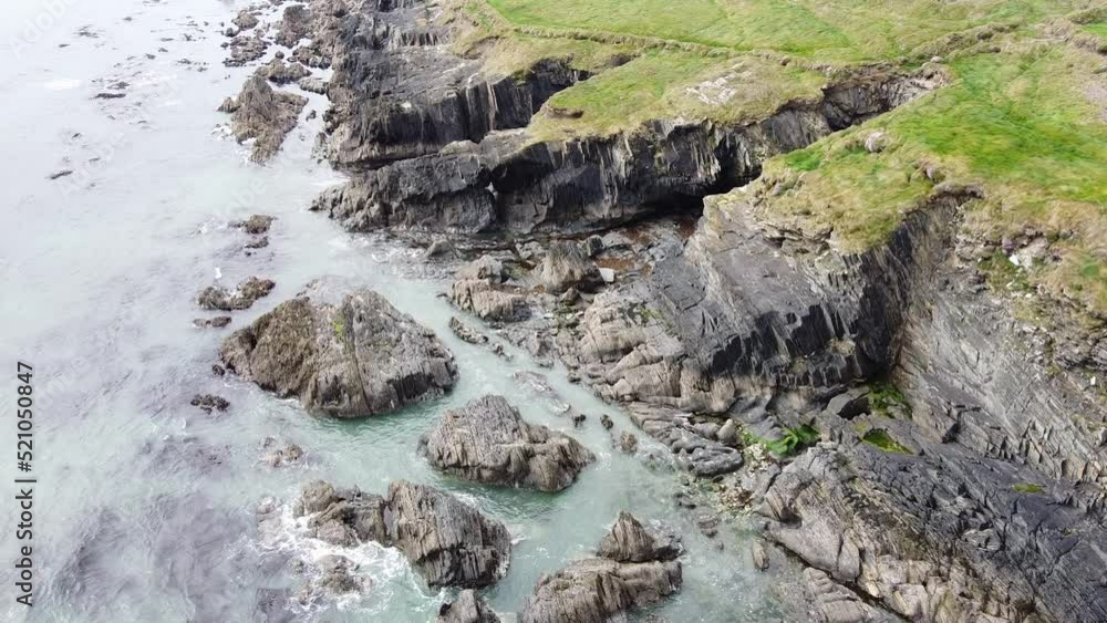 Drone view of the rocky coastline of the Celtic Sea. Sea waves are rushing on the shore. Seascape. Drone view of the rocky coastline of the Celtic Sea. Sea waves are rushing on the shore. Seascape.
