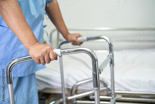 Asian lady woman patient walk with walker at nursing hospital ward, healthy strong medical concept © amazing studio