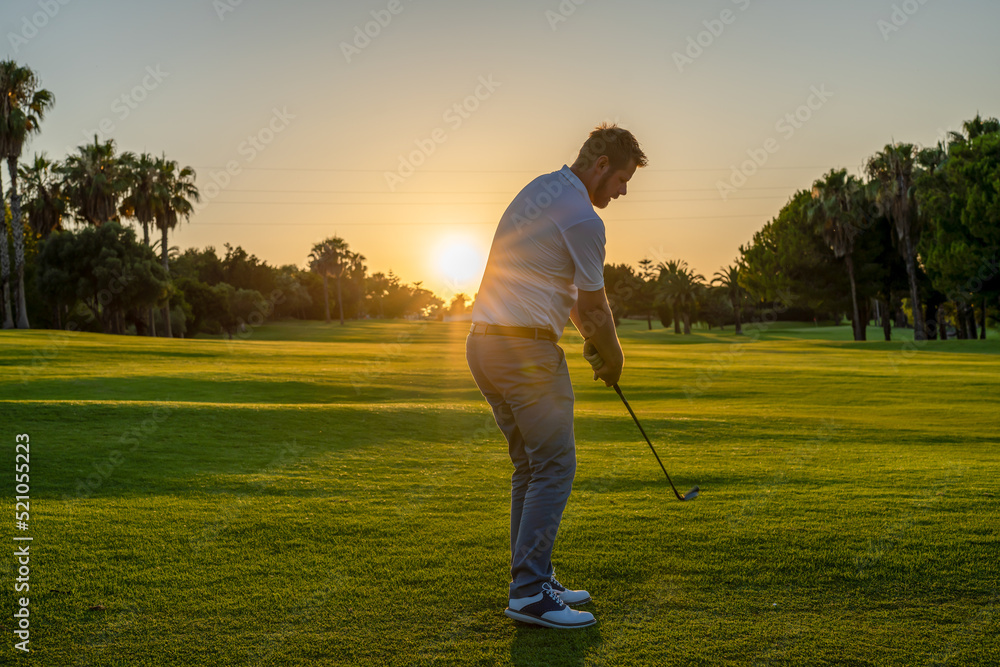 Fototapeta premium Golfer male ready to be struck the ball on green grass on golf course.