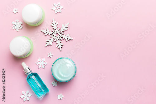 Makeup products and Christmas decorations on color background. Top view New year Beauty concept with copy space