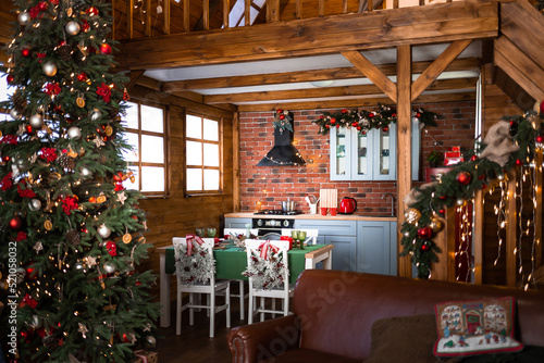 Kitchen is decorated with Christmas garlands and Christmas tree in halet