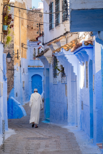 Muslim man walking down the street of Essaouira, Morocco © Ral