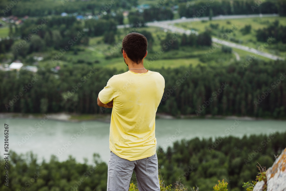 young adult man in the highlands portraint. Tourist in Altai mountains.