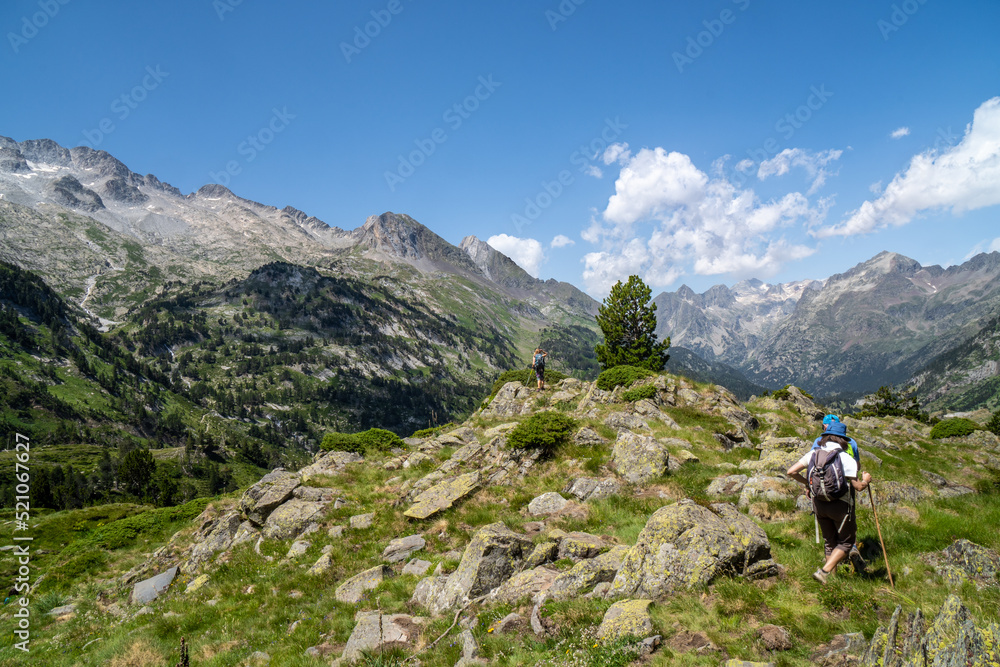 Hikers reaching the top of a mountain to look at the Aragonese Pyrenees