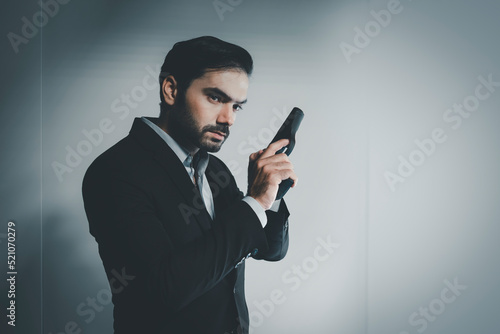 gunman with gun. portrait of serious and attractive hitman or special agent man holding gun. Businessman holding a gun. handgun, assassin. gangster.