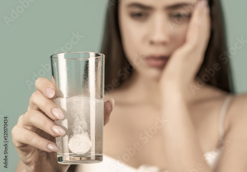 Canvas Print Young woman taking pill against headache