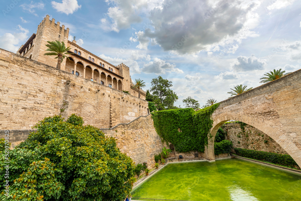 One of the original Moorish gates across a small pond outside the Royal Palace of La Almudaina Alcazar, in Palma de Mallorca, Spain, on the island of Mallorca.