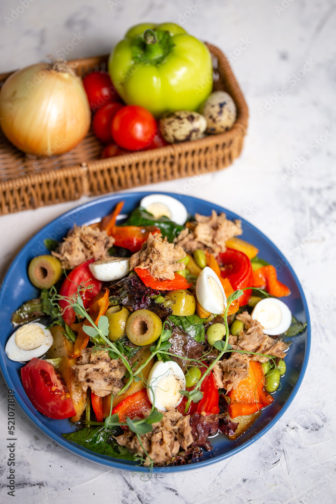 nicoise salad with tuna on the table with vegetables top view