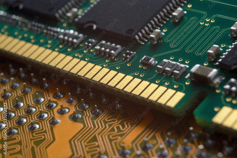 the RAM module from the computer lies on top of the motherboard. close-up the RAM module from the computer lies on top of the motherboard. close-up