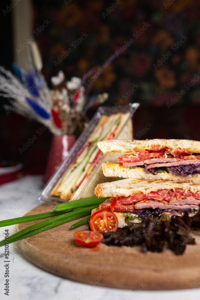 sandwich of bread toasts and vegetables on a wooden board sandwich of bread toasts and vegetables on a wooden board