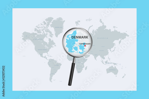 Map of Denmark on political world map with magnifying glass