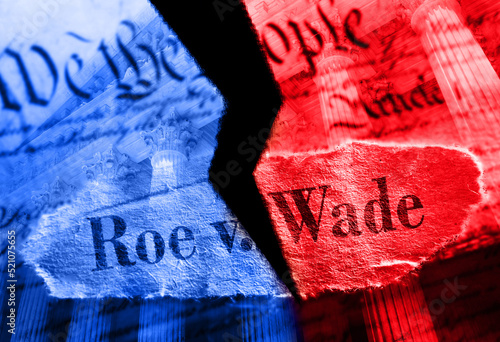 Photo Torn red and blue Roe V Wade newspaper headline on the United States Constitutio
